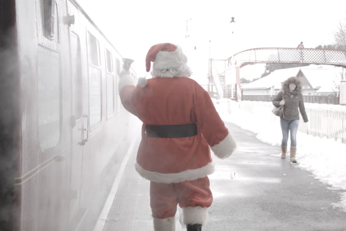 Santa on the platform ringing a bell